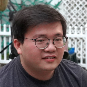A professional portrait of Kevin Tu.